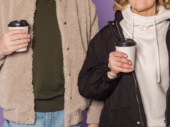 couple holding cup of coffee