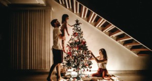 family decorating their christmas tree