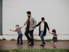 family of four walking at the street