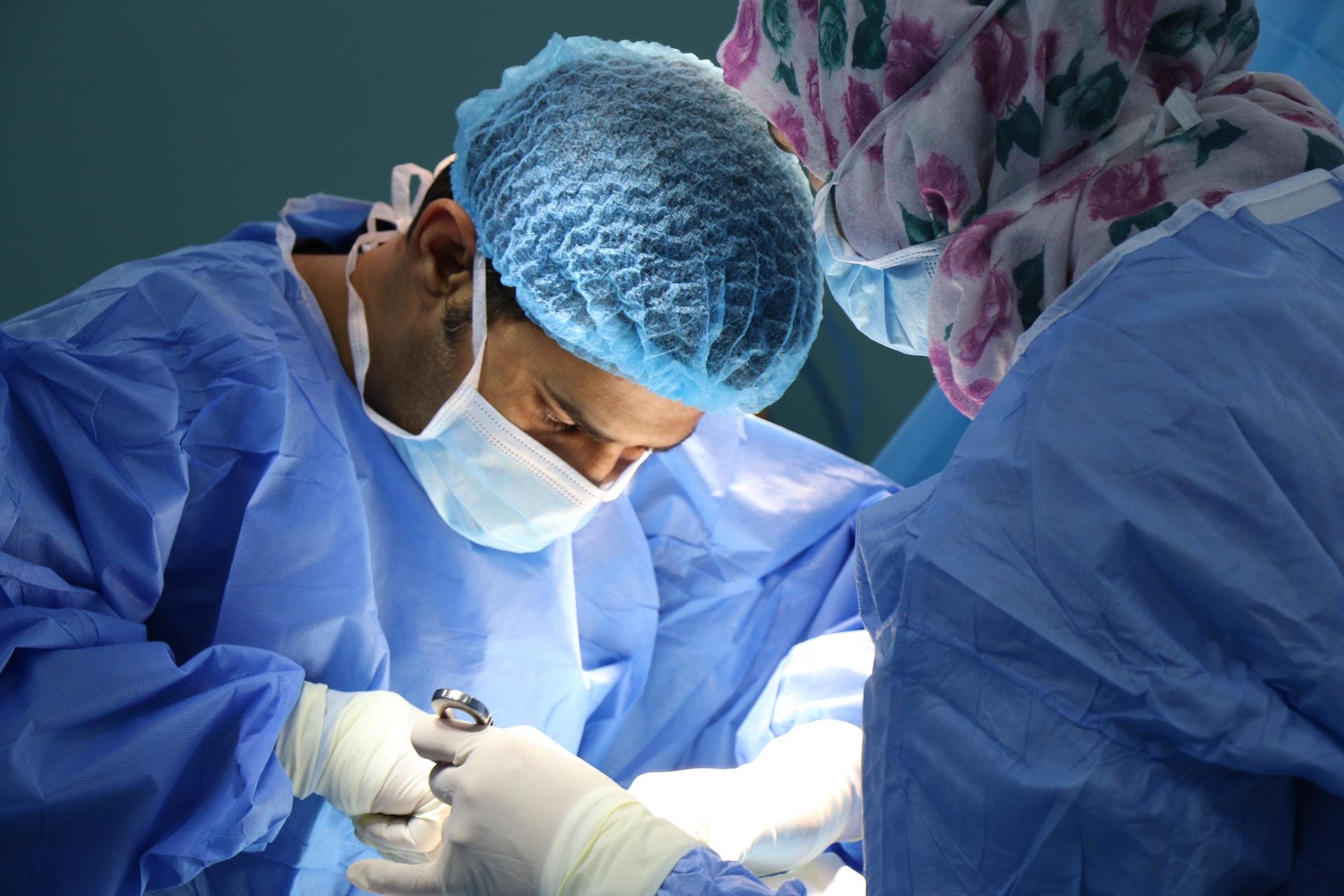 A picture of a surgeon performing an operation on a patient’s hip; ROM Technologies can help in recovery from hip and knee surgeries with the PortableConnect.