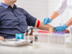 Person receiving a blood test in a clinic.