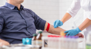 Person receiving a blood test in a clinic.