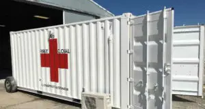 White medical aid shipping container with red cross