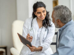 Doctor discussing health with elderly male patient